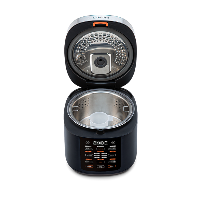 Top-down view into the open Cosori Rice Cooker showing the inner heating plate and lid structure.