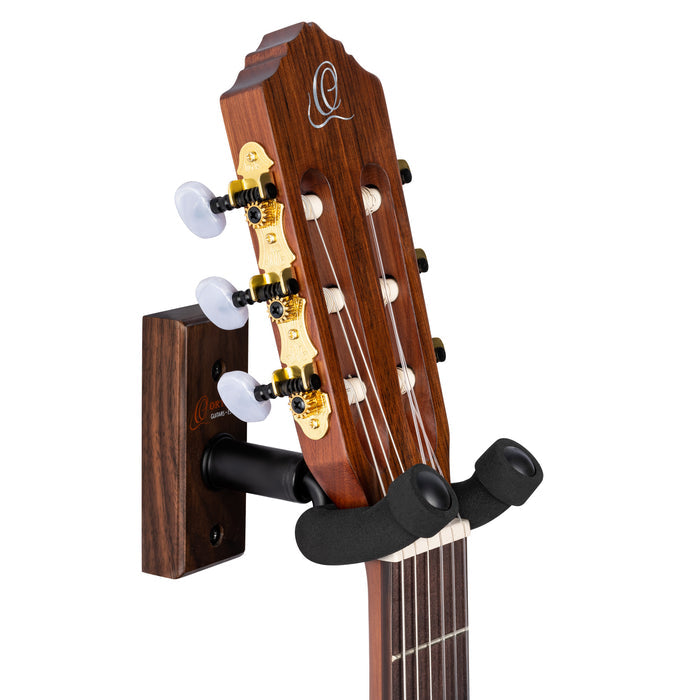 Support mural pour guitare et basse, embase bois, fixation par 2 vis, étrier (largeur: 4.5 cm) recouvert de mousse, noyer